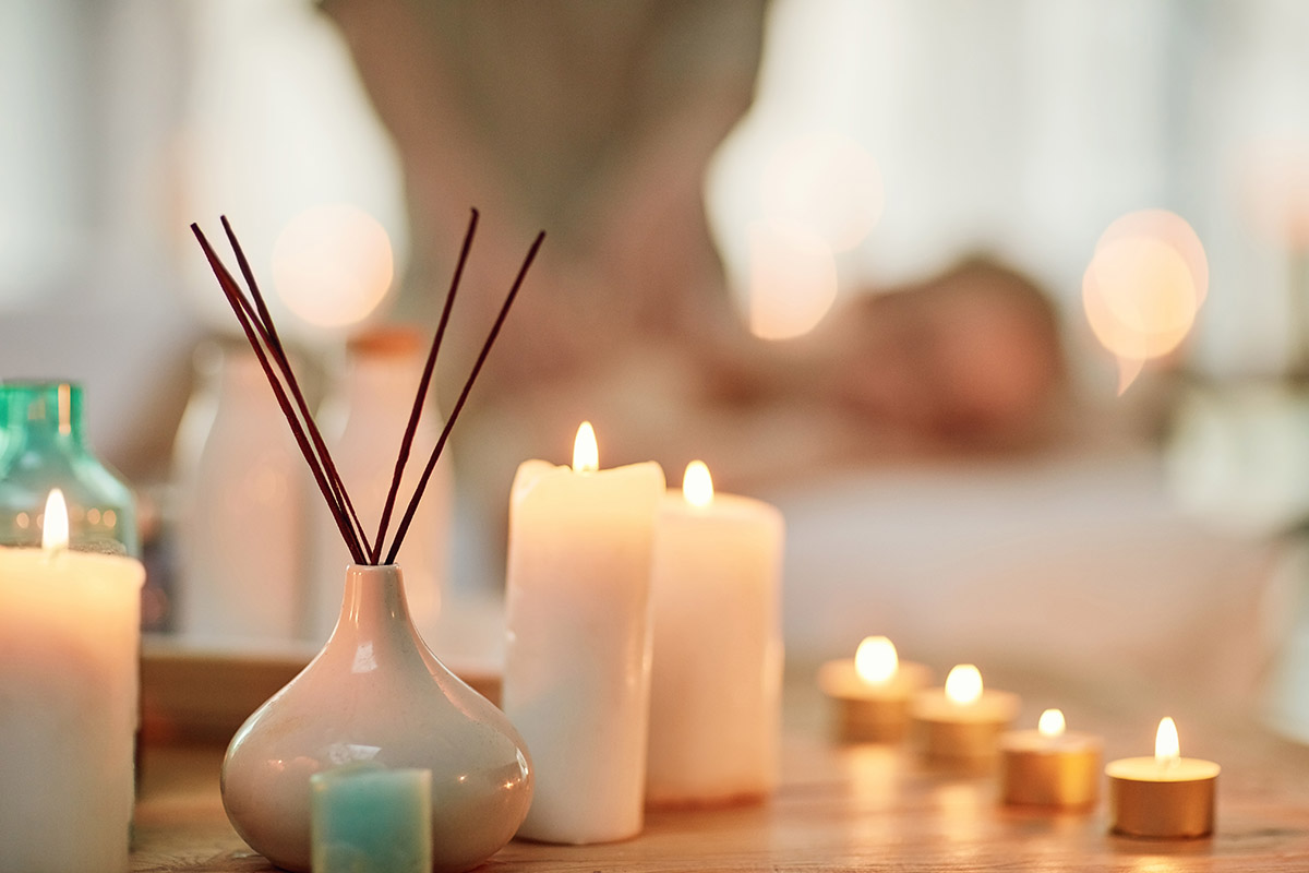 Cropped shot of various pampering essentials in a spa with a young woman in the background